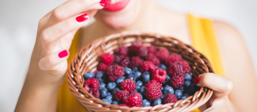 woman eating berries